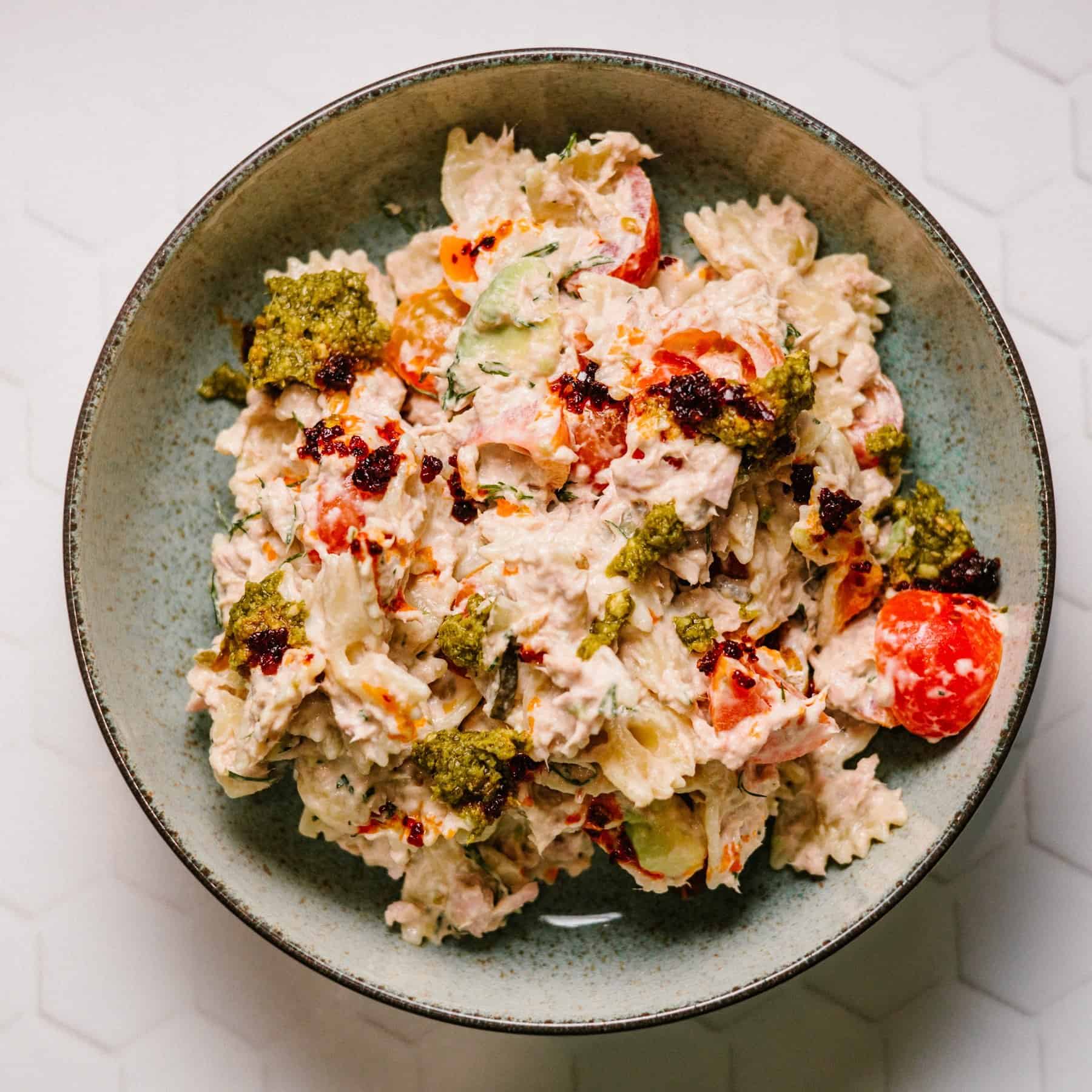 Tunacado Pasta Salad (Joe and the Juice copycat) A bowl of vibrant Tunacado Pasta Salad, featuring cooked pasta, flaked tuna, sliced avocado, diced cherry tomatoes, and a creamy dressing, garnished with fresh dill. An alternative take on the viral sandwich.